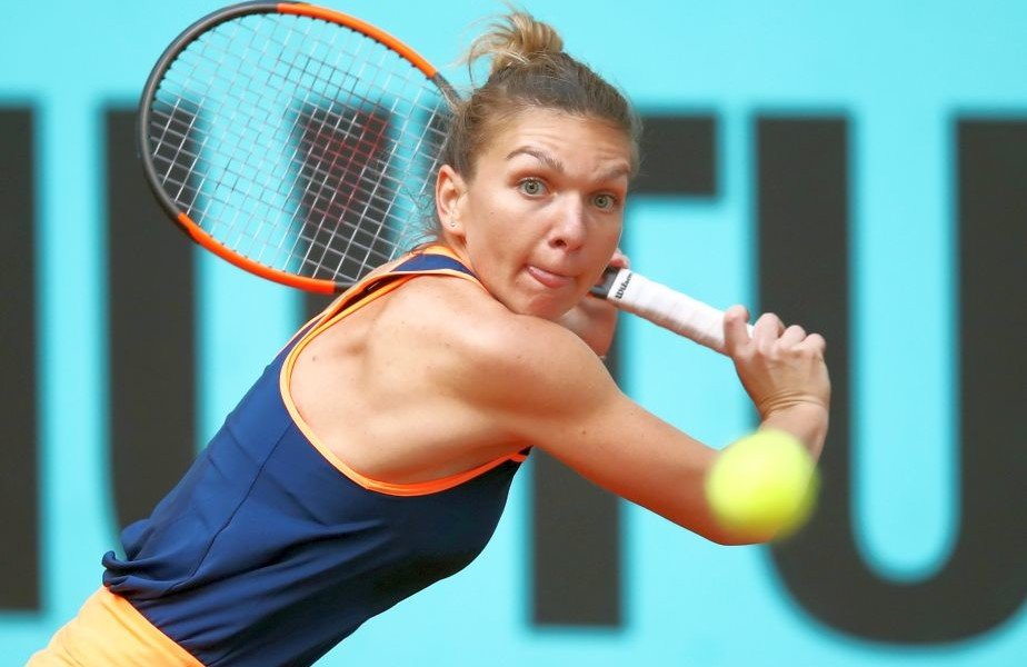 MADRID, SPAIN - MAY 10:  Simona Halep of Romania plays a backhand in her match against Samantha Stosur of Australia during day five of the Mutua Madrid Open tennis at La Caja Magica on May 10, 2017 in Madrid, Spain.  (Photo by Julian Finney/Getty Images)